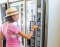 woman buying coffee from automatic vending machine