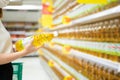 Woman buying cooking oil in supermarket