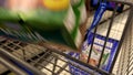 Woman buying Danone Activia yogurt and putting into shopping cart