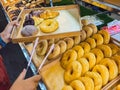 Woman buying donuts in baking store. Female choosing and buying fresh tasty pastry from shelves. Young woman choose freshly baked Royalty Free Stock Photo