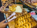 Woman buying donuts in baking store. Female choosing and buying fresh tasty pastry from shelves. Young woman choose freshly baked Royalty Free Stock Photo