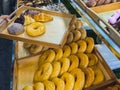 Woman buying donuts in baking store. Female choosing and buying fresh tasty pastry from shelves. Young woman choose freshly baked Royalty Free Stock Photo