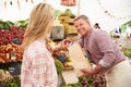 Woman Buying Fresh Vegetables At Farmers Market Stall Royalty Free Stock Photo