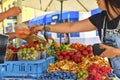 Woman buying fruits and vegetables at farmers market. Sustainable lifestyle. Fresh organic produce for sale at local Royalty Free Stock Photo