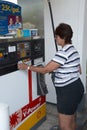 Woman purchasing gasoline at a gas pump in Belleville, Michigan