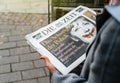 Woman buying German Die Zeit newspaper with Angela Merkel Royalty Free Stock Photo