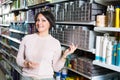 Woman buying hair colourant in store