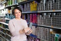 Woman buying hair colourant in store