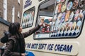 Woman buying ice-cream from Mr. Whippy van in Covent Garden, London, UK.