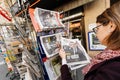 Woman buying international press with Emmanuel Macron Liberation