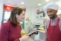 Woman buying meat from butcher Royalty Free Stock Photo