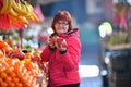 Woman buying nar fruit at market place