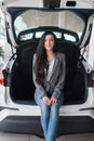 Woman buying new car, lady near the opened trunk Royalty Free Stock Photo