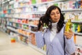 Woman buying new oil in hair care store Royalty Free Stock Photo