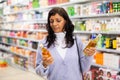 Woman buying new oil in hair care store Royalty Free Stock Photo