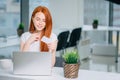 Woman buying online with laptot and looking at credit card Royalty Free Stock Photo