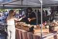 Woman buying pastries in a stall at the Kings Cross Real Food Market in London