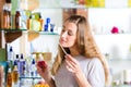 Woman buying perfume in shop or store