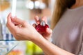 Woman buying perfume in shop or store