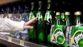 Woman buying Perrier carbonated natural spring water