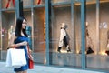 Happy Asia Chinese Eastern oriental young trendy woman girl shopping in mall with bags shopping window background on street city Royalty Free Stock Photo