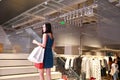 Happy Asia Chinese Eastern oriental young trendy woman girl shopping in mall with bags shopping window background on street city Royalty Free Stock Photo