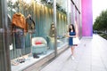 Happy Asia Chinese Eastern oriental young trendy woman girl shopping in mall with bags shopping window background on street city Royalty Free Stock Photo