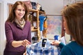 Woman Buying Shirt In Charity Shop Royalty Free Stock Photo