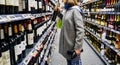 Woman buying shopping for wine in supermarket France Royalty Free Stock Photo