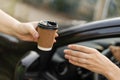 Woman buying takeaway coffee sitting in her car Royalty Free Stock Photo