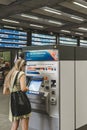 Woman buying a train ticket at the automatic ticket vending machine in St Pancras International Royalty Free Stock Photo