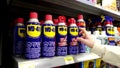 Woman buying WD-40 big blast grande vague