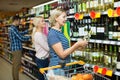 Woman buying wine in supermarket Royalty Free Stock Photo