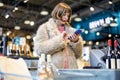 Woman buying wine in supermarket Royalty Free Stock Photo