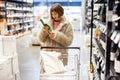 Woman buying wine at supermarket Royalty Free Stock Photo