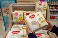 Woman buys diapers Huggies at the supermarket. Minsk, Belarus - March 2021