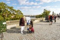 A woman buys local souvenirs from a street vendor on the Charles Bridge in Prague Czechia