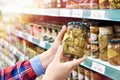 Woman buys salted mushrooms in store