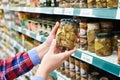 Woman buys salted mushrooms in store