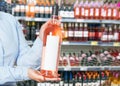 Woman buys wine in shop