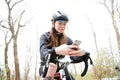 Woman on bycicle using smartphone Royalty Free Stock Photo