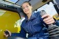 Woman in cab industrial vehicle