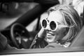 Woman in cabriolet car is happy. Young woman driving on road trip on beautiful summer day. Pretty Caucasian female model Royalty Free Stock Photo