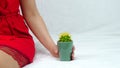 A woman with a cactus in her hand. The concept of body care, hair removal. Royalty Free Stock Photo