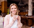 Woman in cafe drinking coffee, enjoying her espresso Royalty Free Stock Photo