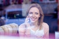 Woman in cafe drinking coffee, making a phone call Royalty Free Stock Photo