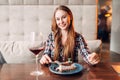 Woman in cafe, sweet cake and wine on the table Royalty Free Stock Photo