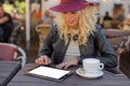 Woman at cafe using tablet computer Royalty Free Stock Photo