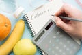 Woman calculating calories in paper notebook Royalty Free Stock Photo