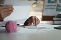 Woman calculating her Debt. woman hand calculating her monthly expenses during tax season with coins, calculator and Royalty Free Stock Photo